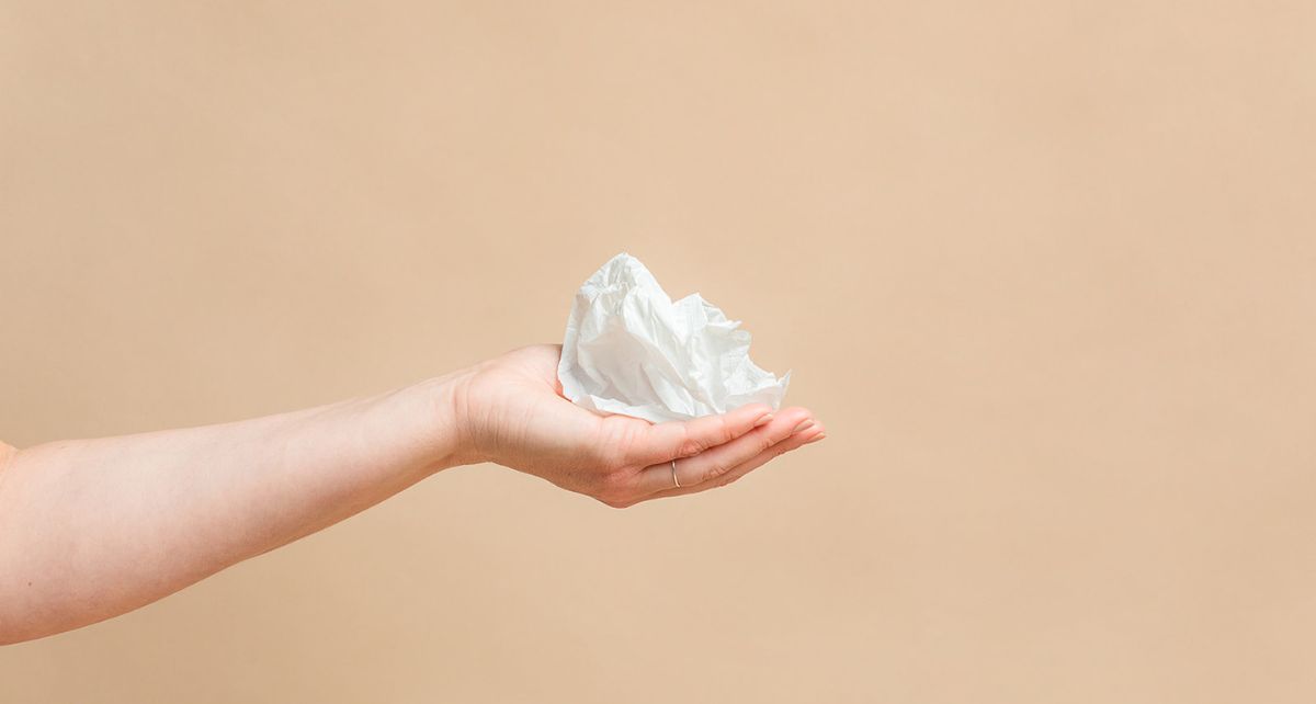 Hand holding compostable bioplastic wrapper from joni pads