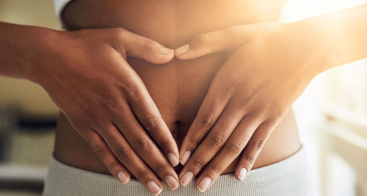 Woman in white underwear holds her gut