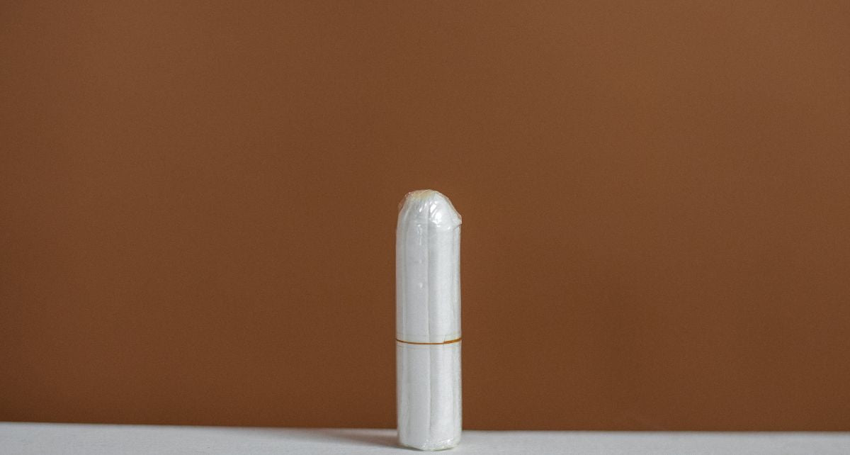 A single applicator-free tampon with a brown background