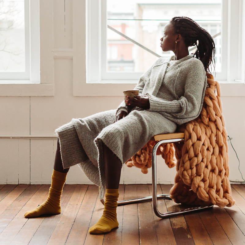 A woman with PMDD looks out a window