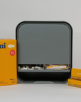 joni Model A open dispenser on grey background with pads and tampons