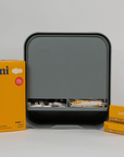 joni Model A open dispenser on grey background with pads and tampons