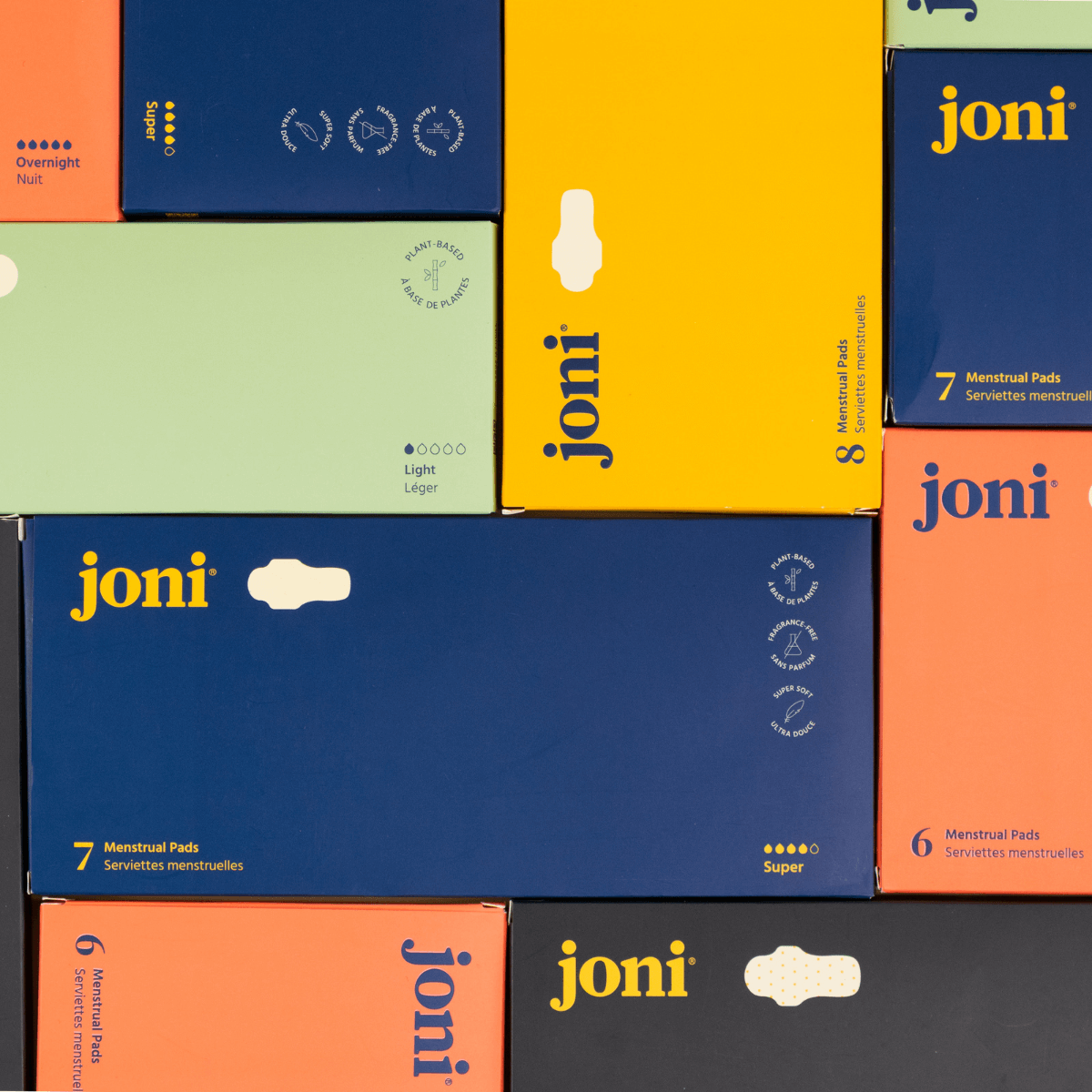 Colorful boxes of joni menstrual pads, showcasing various types and sizes for period care.
