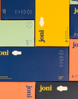 Colorful boxes of joni menstrual pads, showcasing various types and sizes for period care.