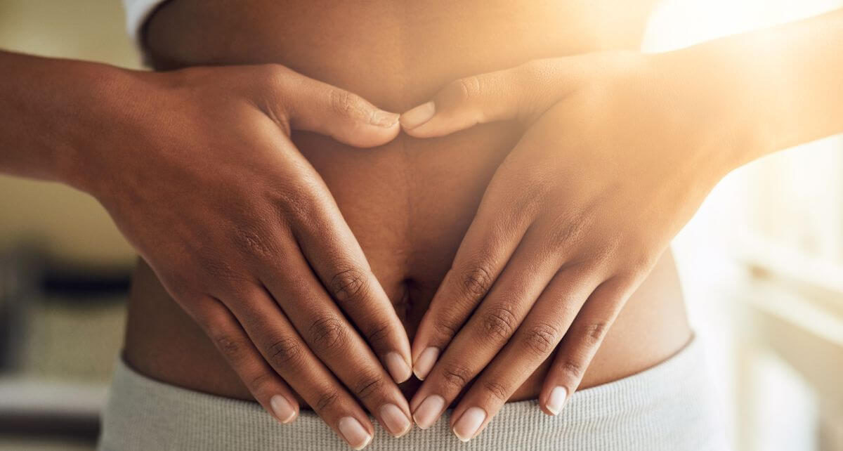 Woman in white underwear holds her gut
