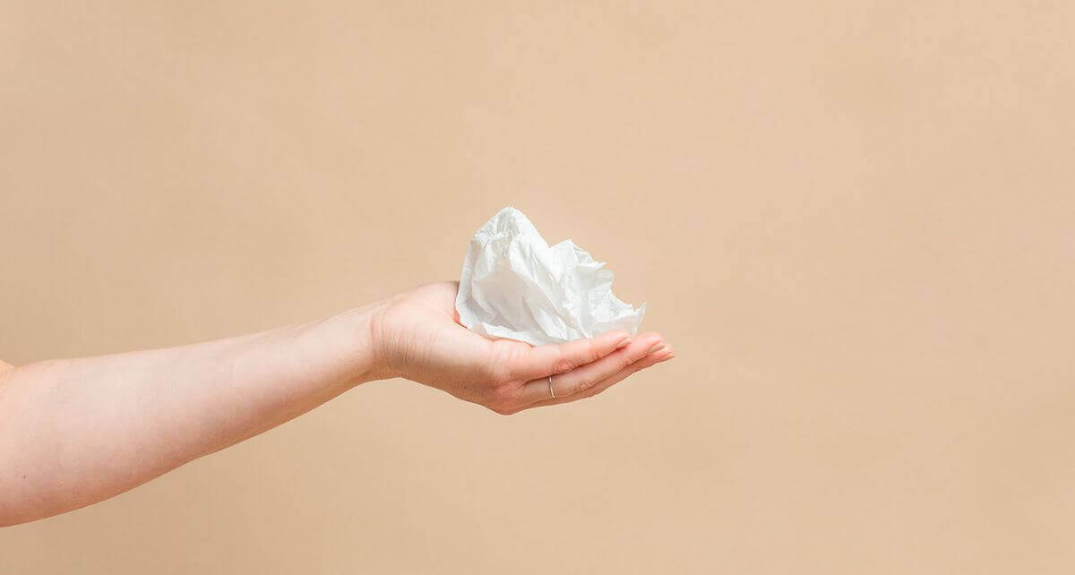 Hand holding compostable bioplastic wrapper from joni pads