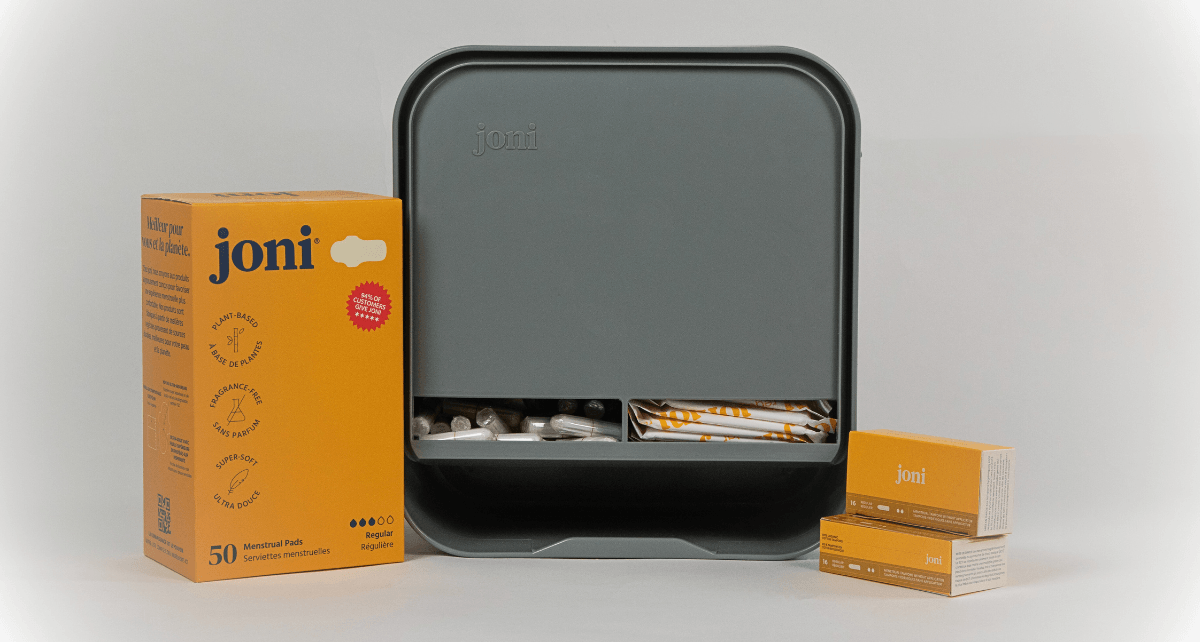 JONI Model A dispenser on counter with regular pads and tampons