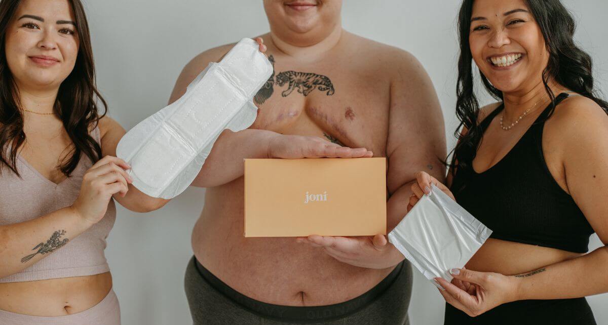 Diverse menstruators holding period products