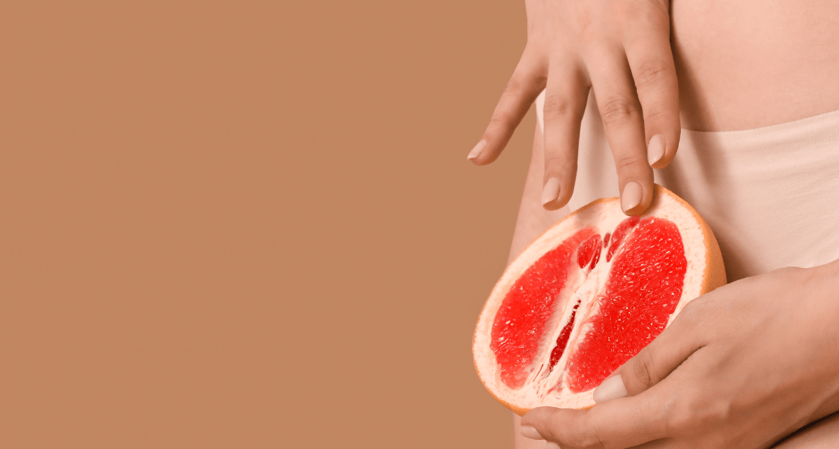 Hands holding a grapefruit that's cut open