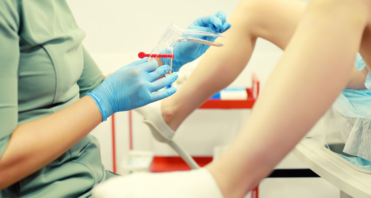 woman on medical table with a doctor to take a pap test