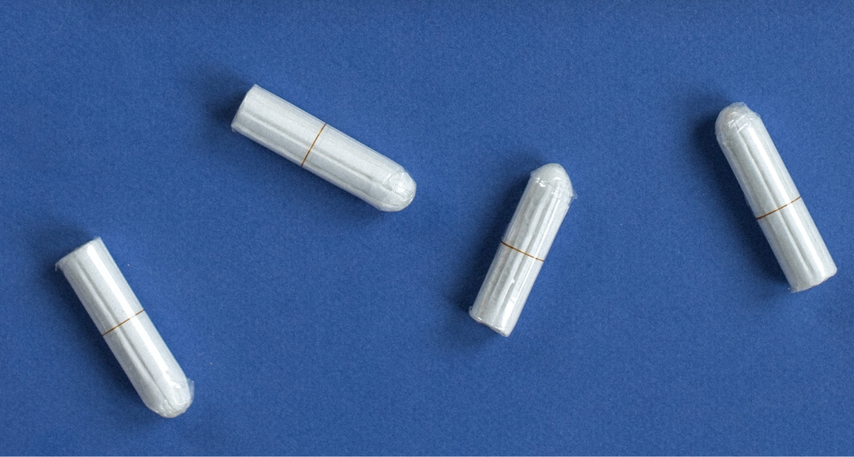 Tampons on a blue counter representing menstrual care in the workplace