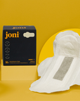 Organic Bamboo Incontinence Pads by joni, featuring ultra-thin and leak-proof design, displayed against a vibrant yellow background.