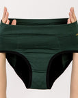 Dark green joni high-waisted leakproof period underwear  briefs held up by a person's hands against a plain light background.