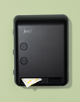 joni Model V smart period care dispenser on a green background